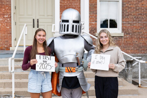 Two students pose with Sir Victor in front of Old Main of the first day of Fall Term 2025.