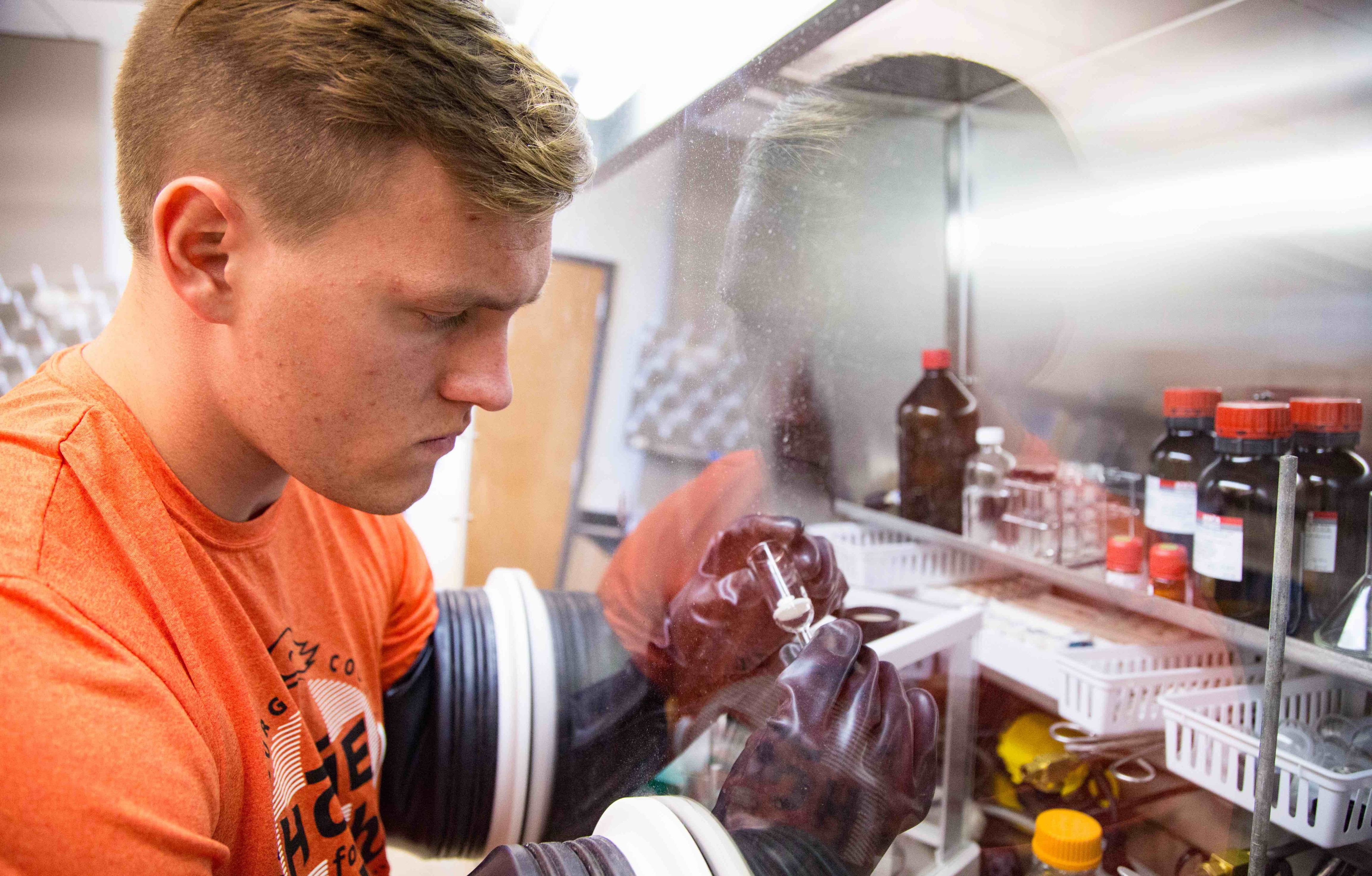 Caleb Milius uses the dry box in the chemistry lab.