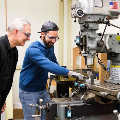 Taha Al-azzawi ’18 and Dr. Daniel Black watch as the newly automated drill completes a project.
