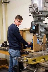 Jake Hamilton ’18 programs the automated mill for a project.