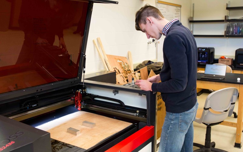 Jake Hamilton ’18 programs a new project for the laser printer in the Innovation Studio.