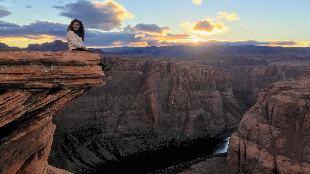 Rocio Ayard Ochoa sits atop a ledge along the Grand Canyon.