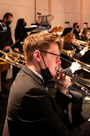 Spencer Dodgen playing the trombone during a Wind Ensemble concert