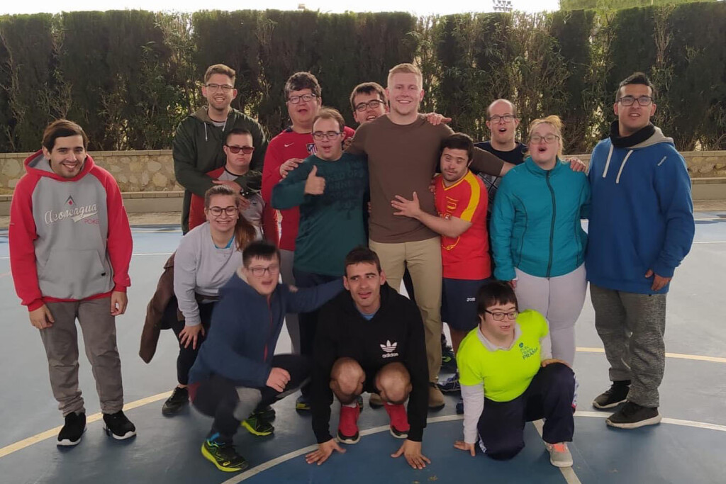 Tanner Duffy poses with a group of adults with disabilities he worked with while studying abroad in Alicante, Spain.