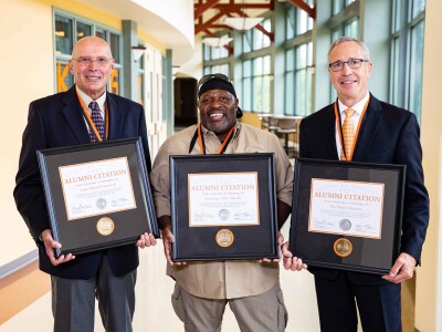 2020 Alumni citation recipients Capt. Dan Grinstead, Lawrence “DC” Randle and Daniel Hanson hold their citations