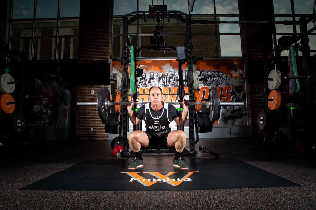 Mark Swinton poses in a squat in the new Meyer Strength & Conditioning Annex.