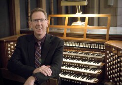 Robert Hobby sits in front of an organ