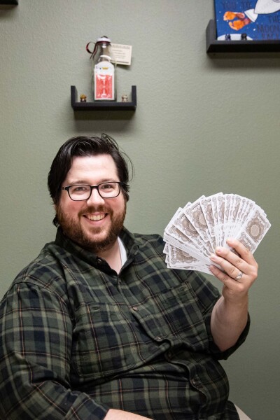 Kyle Fleming Kyle Fleming fans a magic deck of cards in his office on the Wartburg campus.