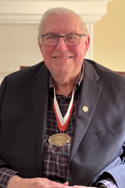 Bill Hamm wears his newly bestowed Wartburg Medal over a blue suit coat