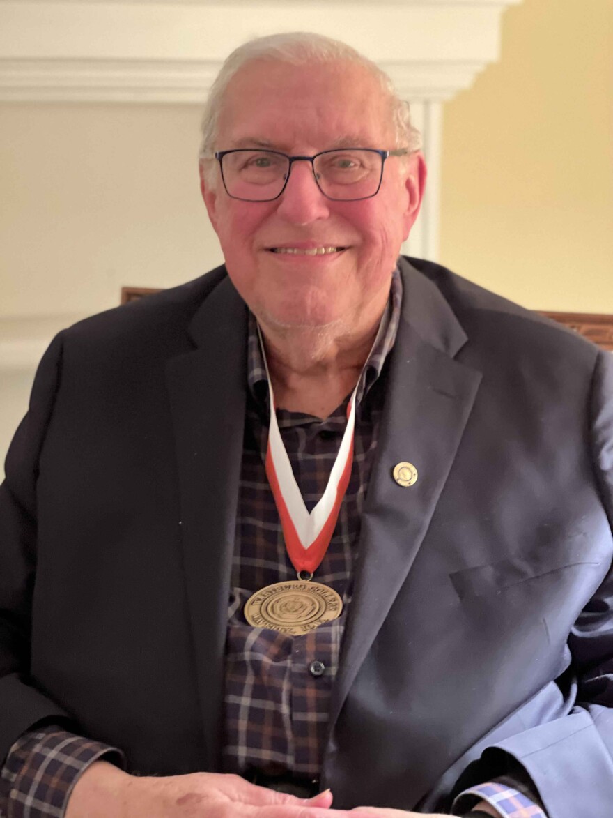 Bill Hamm wears his newly bestowed Wartburg Medal over a blue suit coat