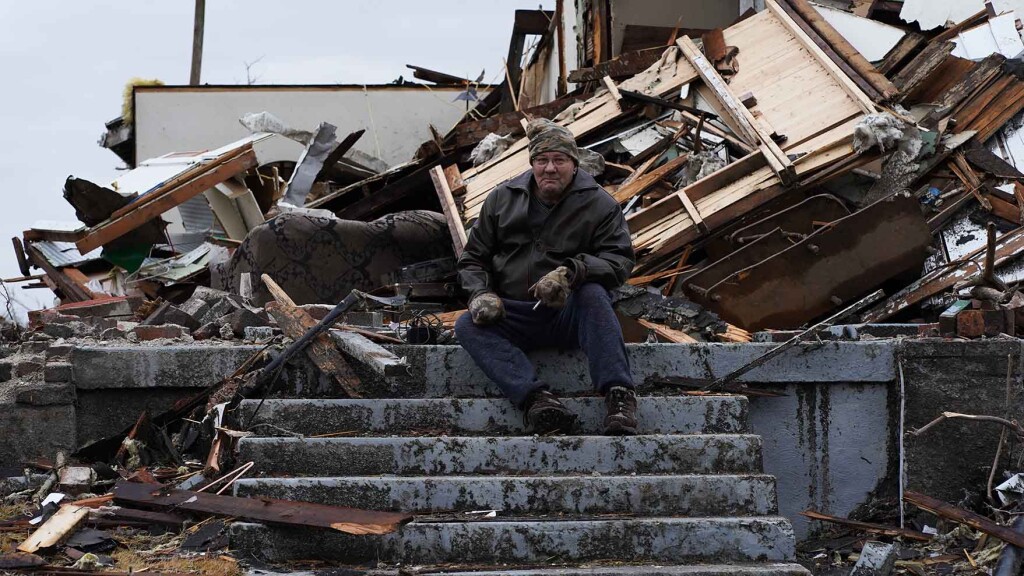 In this photo by Jonathon Gregg, a man sits on the stairs of what is left of his home following a devastating tornado.