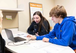 Wartburg students work with adjunct professor Annie Vander Werff to record public service announcements for World Grace Project, a Cedar Valley nonprofit, for a public health course.