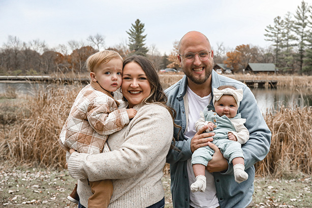 Haley and Myles Finn holding their two children